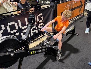 A young boy doing hyrox