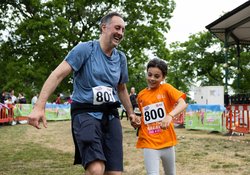A man and child finishing the mini marathon together