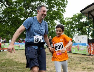 A man and child finishing the mini marathon together