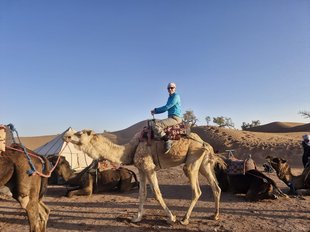 Ella on a camel during the Sahara trek